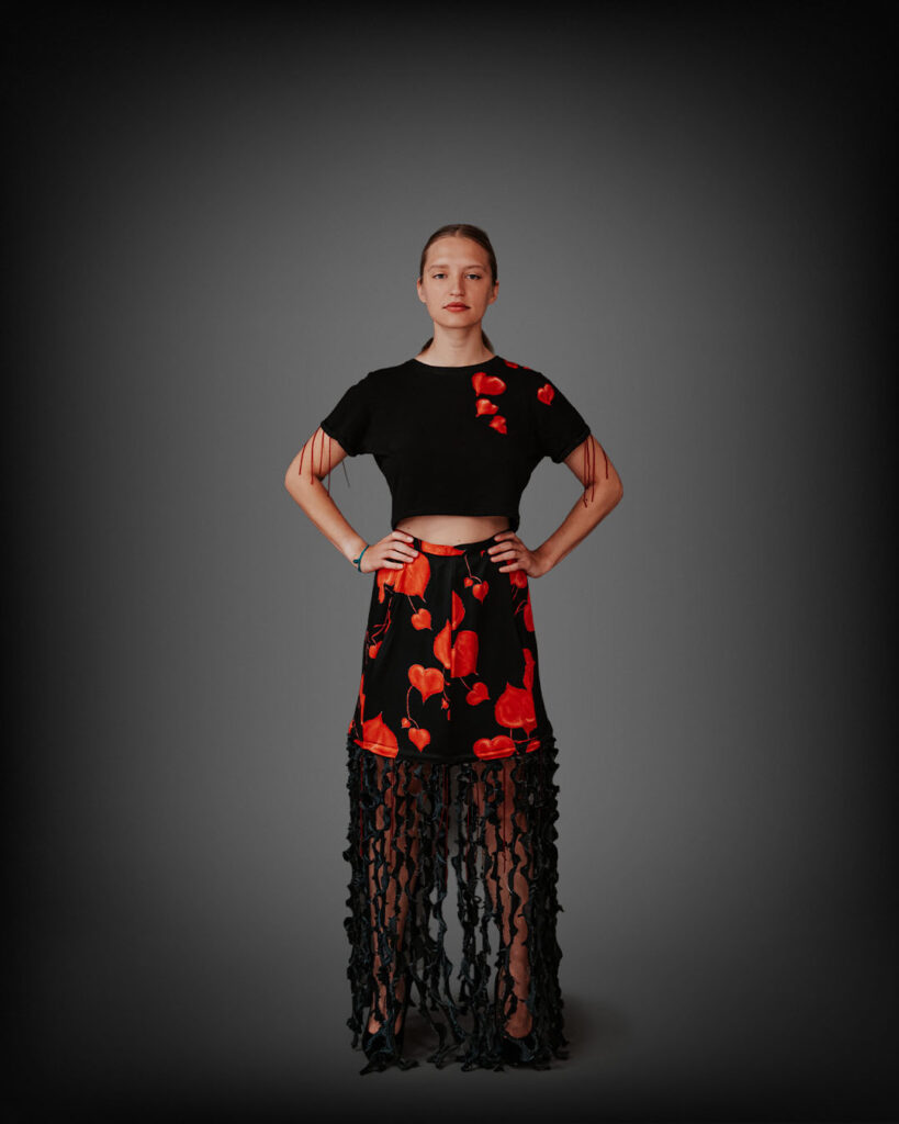 a woman in a black top and red skirt