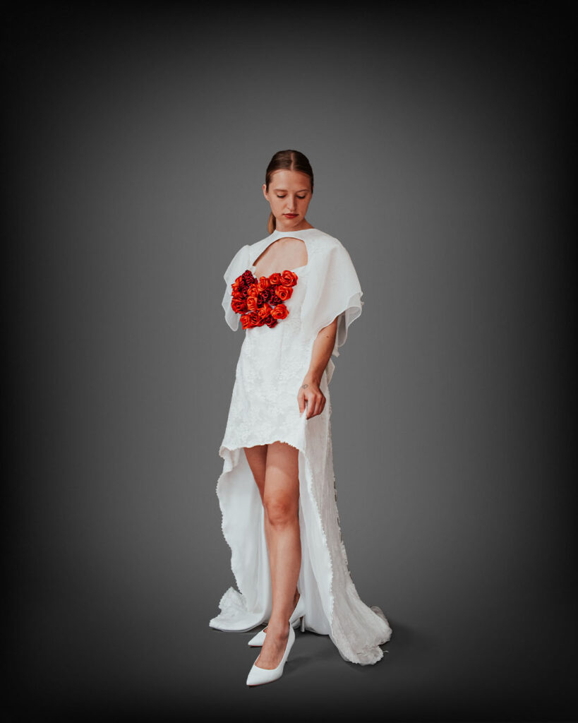 a woman in a white dress holding a bouquet of flowers