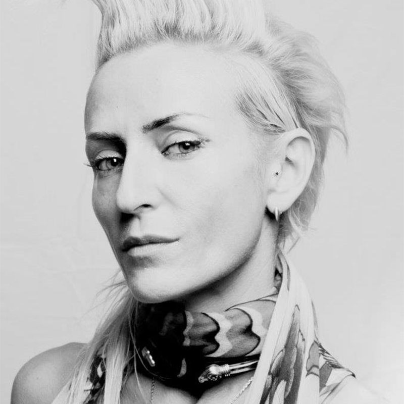 a black and white photo of a woman with a scarf around her neck