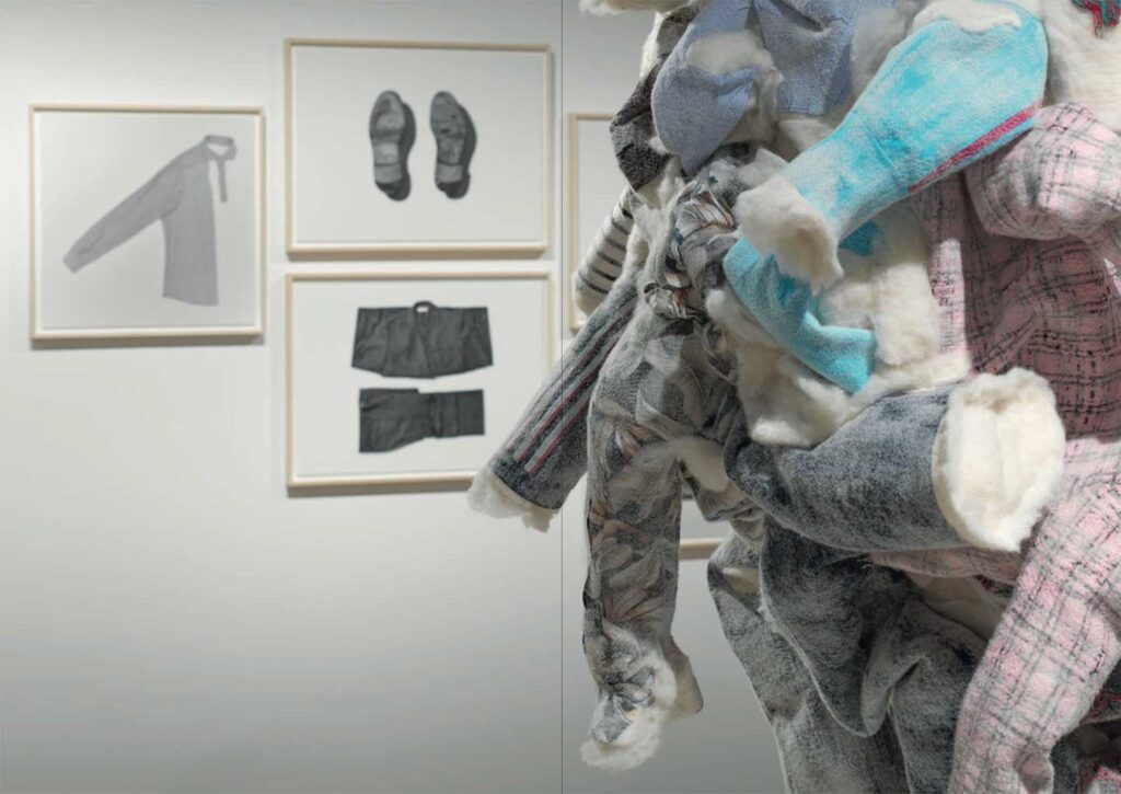 a stuffed animal in a room with pictures on the wall