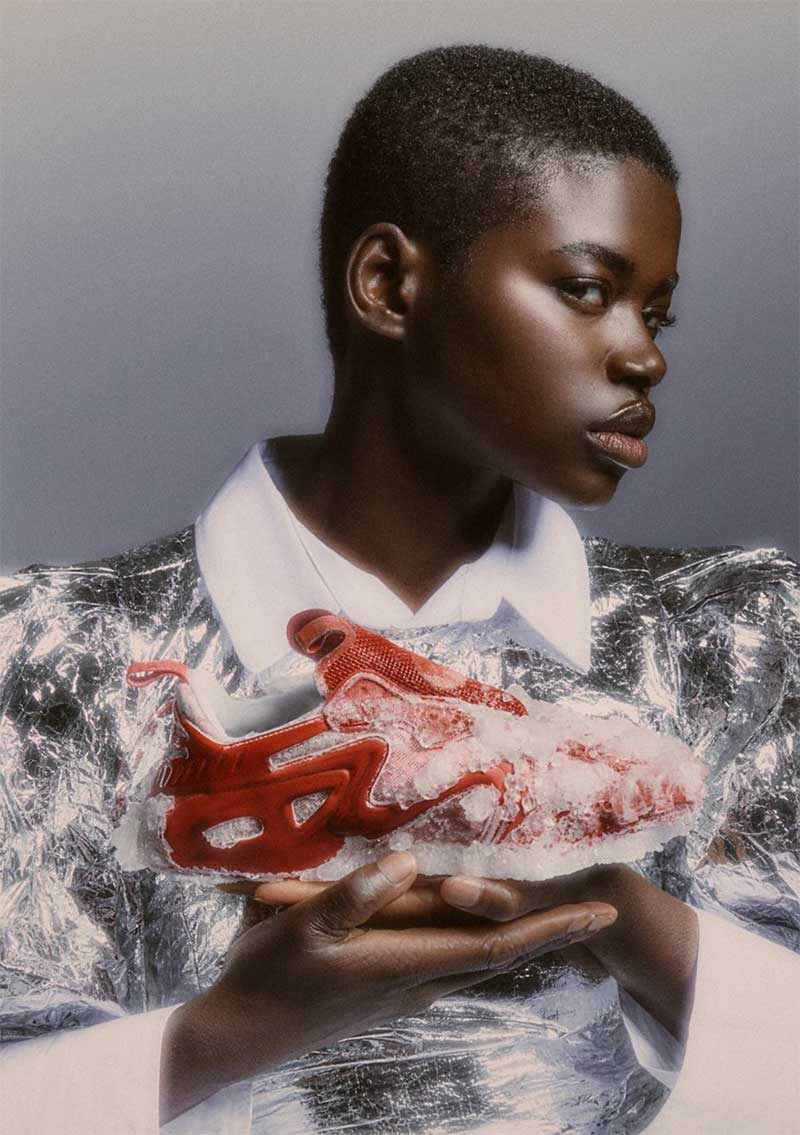 a man holding a piece of meat wrapped in foil