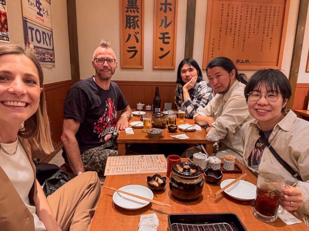 a group of people sitting around a wooden table