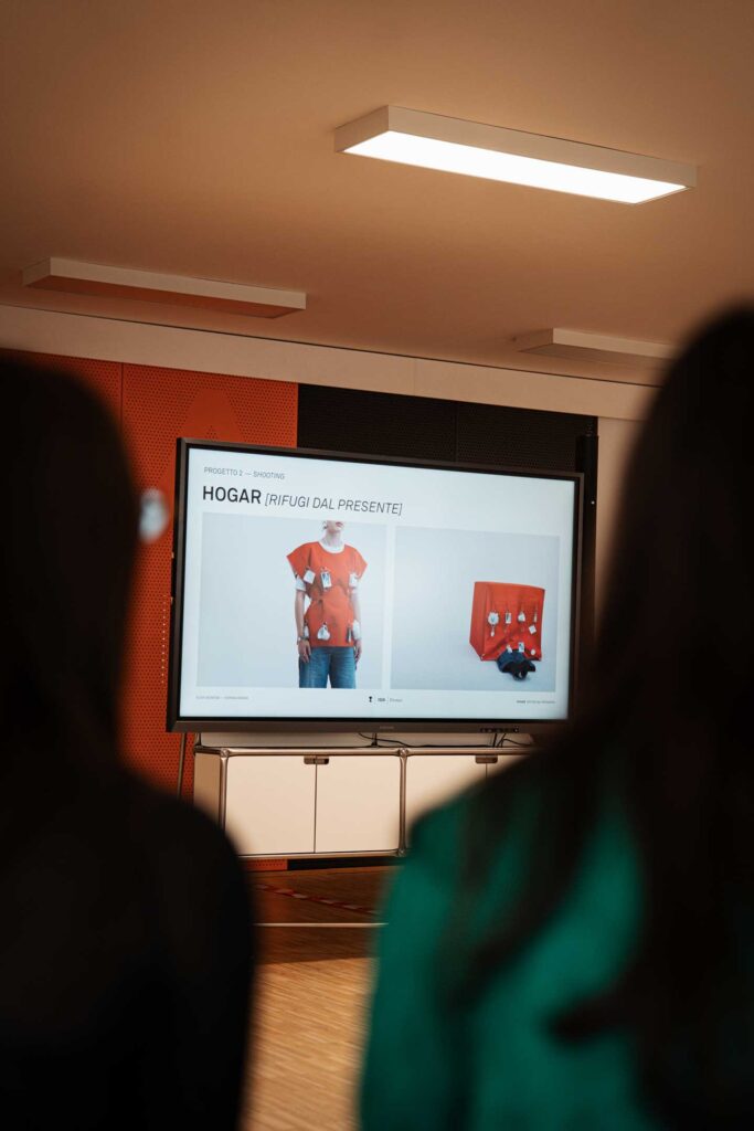 a group of people watching a presentation on a large screen