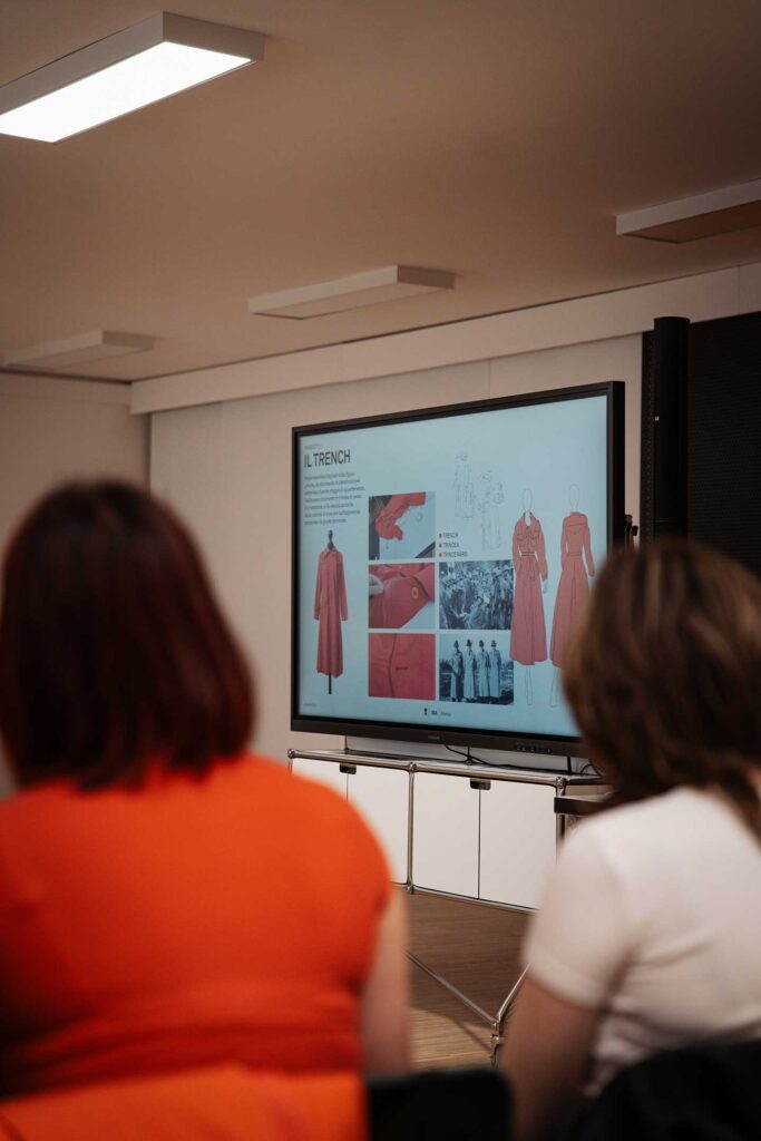 a group of people sitting in front of a projector screen