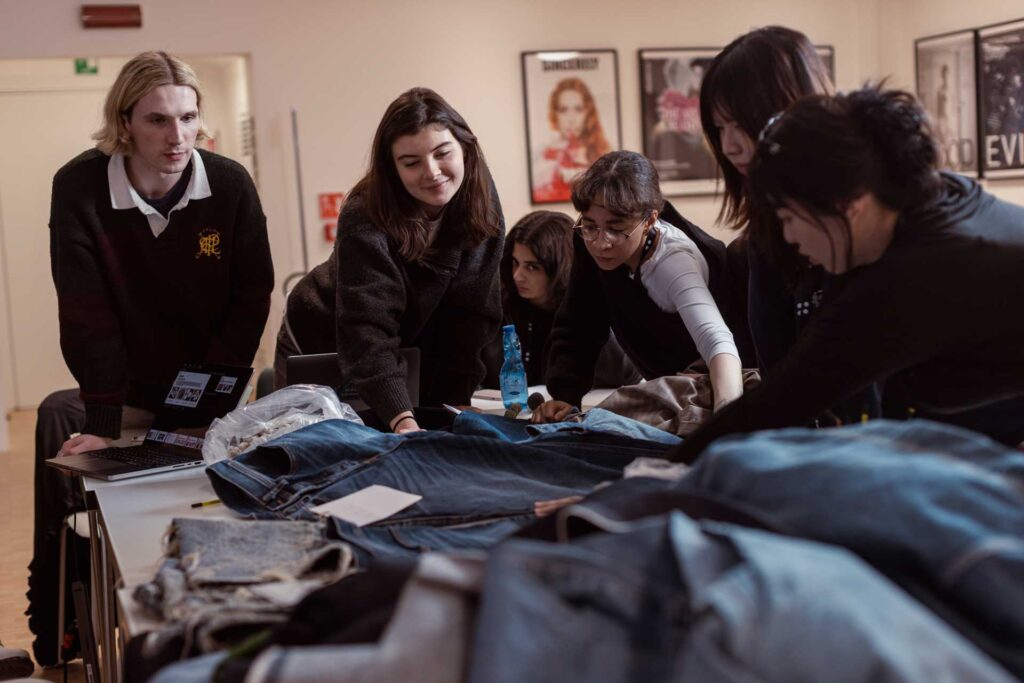 a group of people looking at clothes on a table