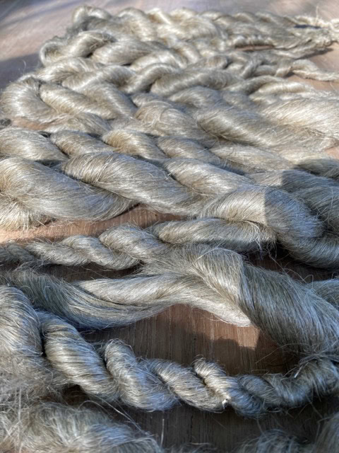 a close up of a rope on a wooden surface