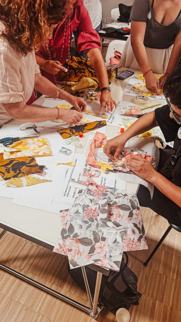 a group of people sitting around a table working on a project
