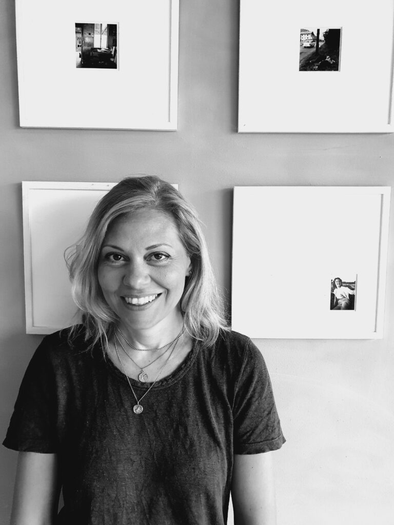 a black and white photo of a woman smiling