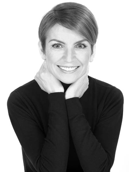 a black and white photo of a smiling woman