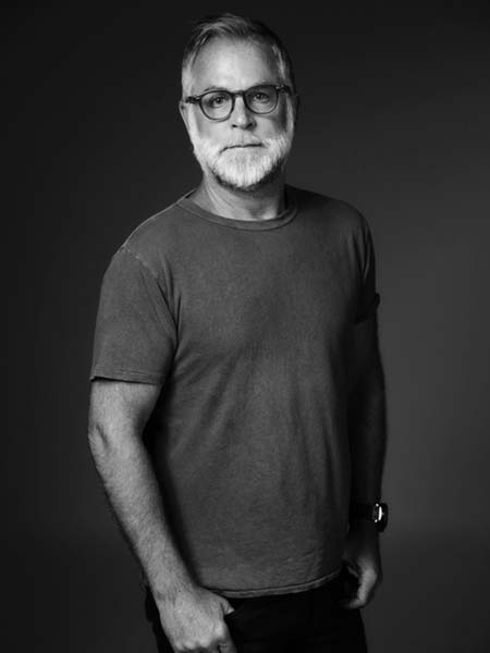 a black and white photo of a man with glasses