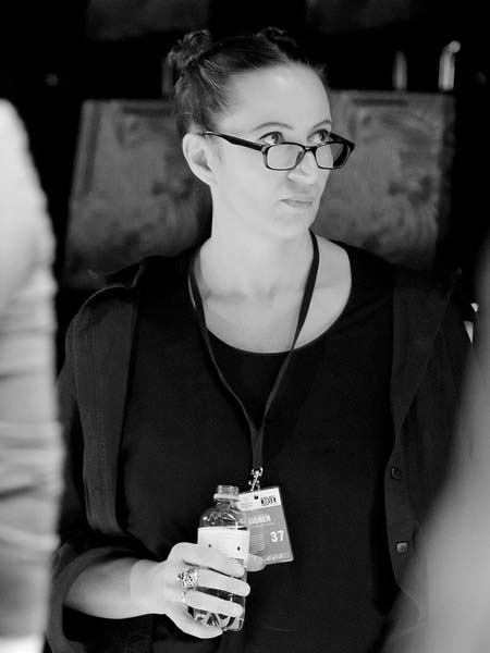 a woman with glasses holding a box of food