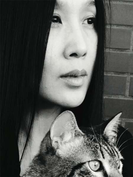 a black and white photo of a woman holding a cat