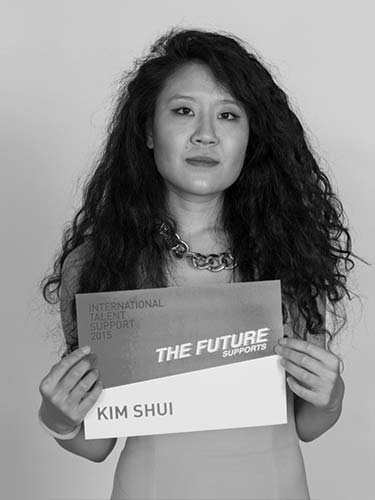 a black and white photo of a woman holding a sign