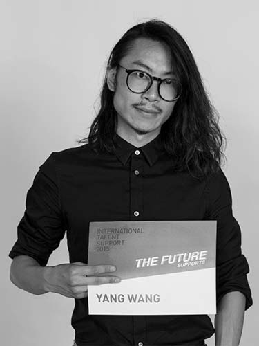 a man holding a sign that says the future yangg wang