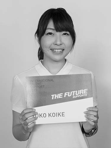 a black and white photo of a woman holding a sign