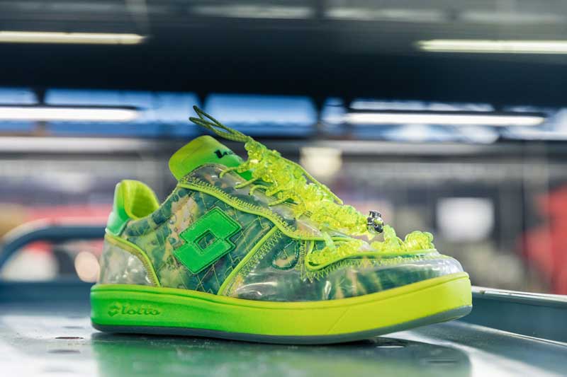 a pair of neon green sneakers on a conveyor belt