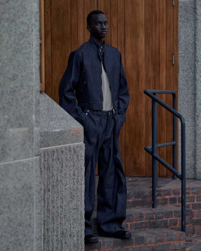 a man in a suit standing in front of a door