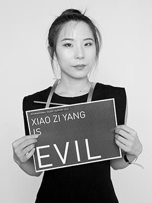 a woman holding a sign that says evil