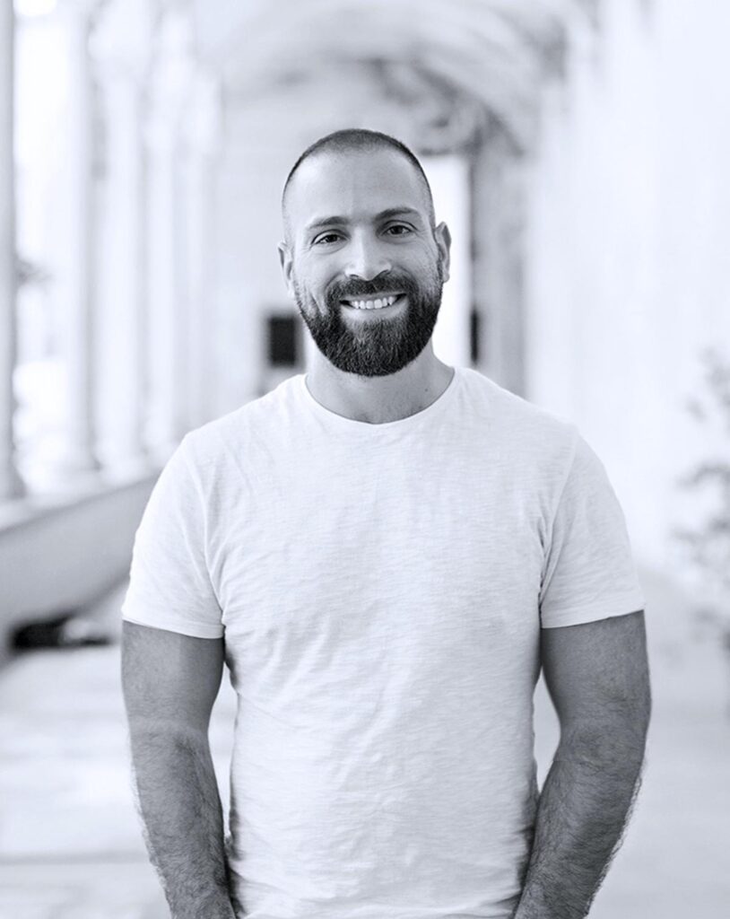 a black and white photo of a man with a beard