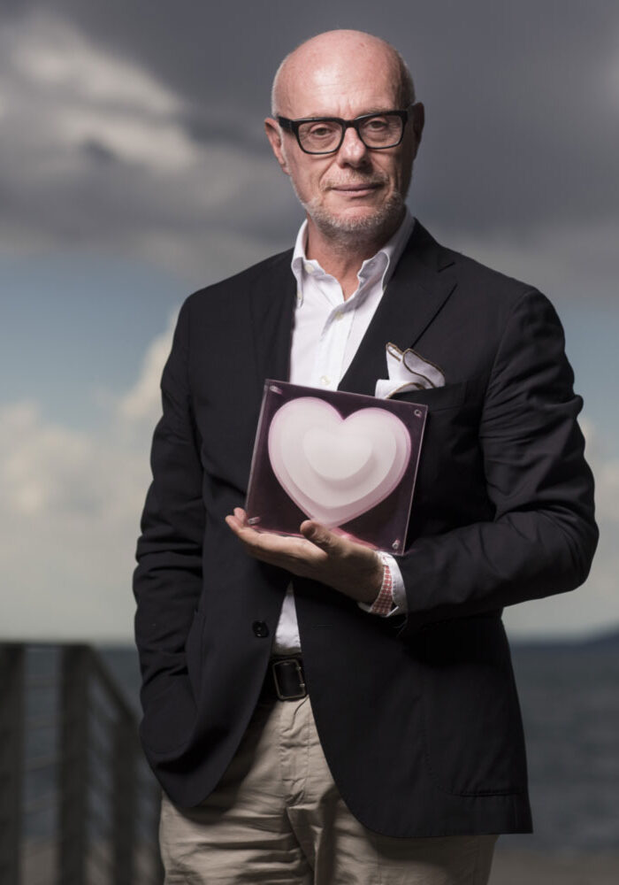 a man in a suit holding a heart shaped object