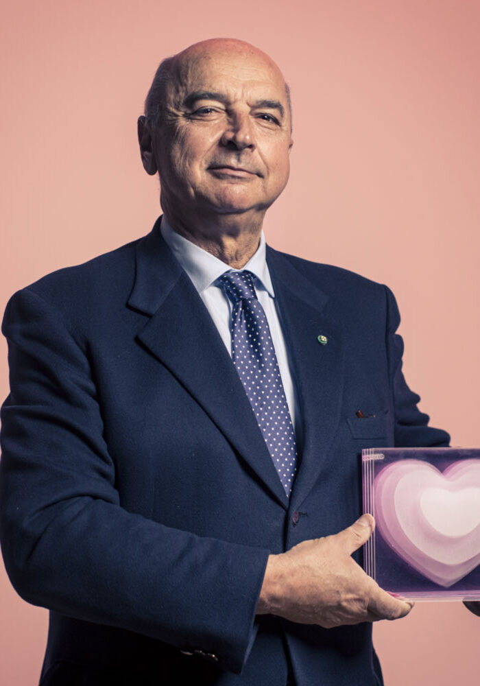 a man in a suit holding a heart shaped box