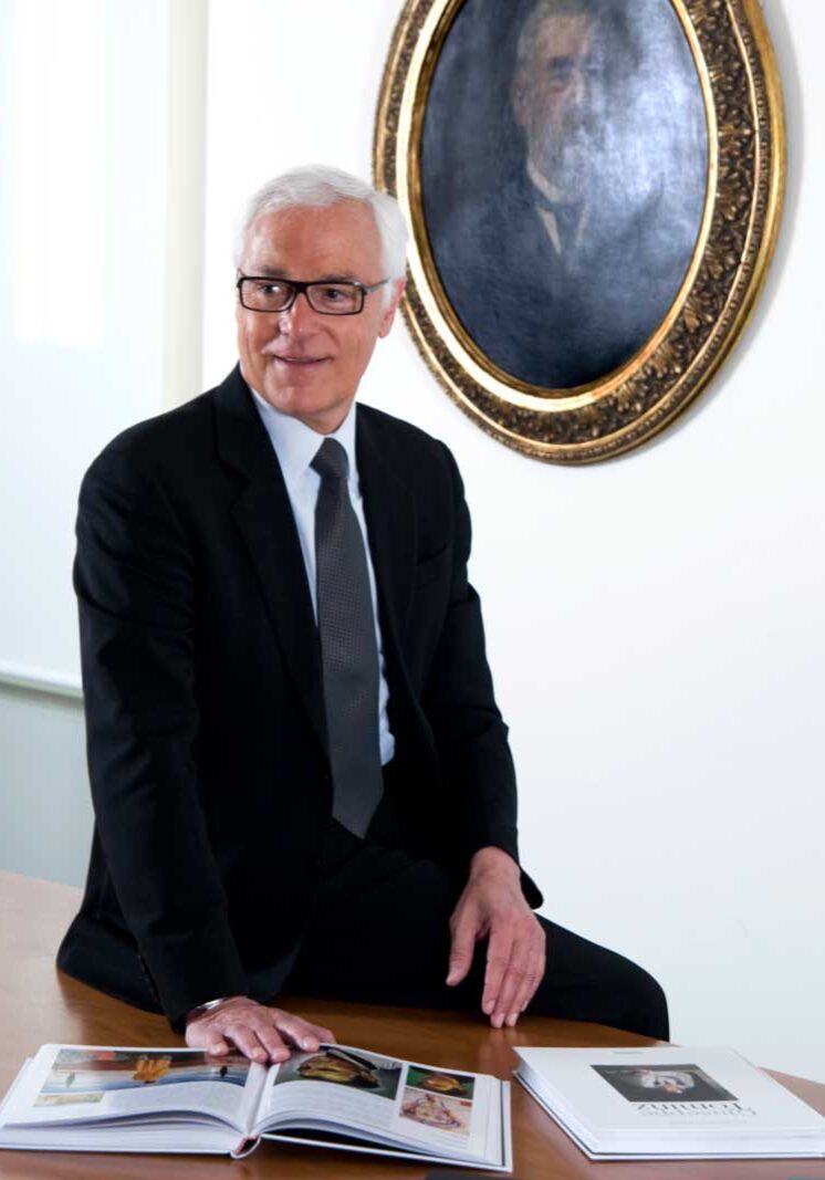 a man in a suit and tie sitting at a table