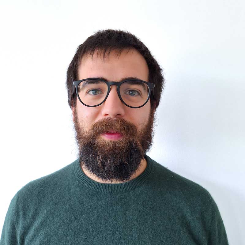 a man with a beard and glasses making a funny face