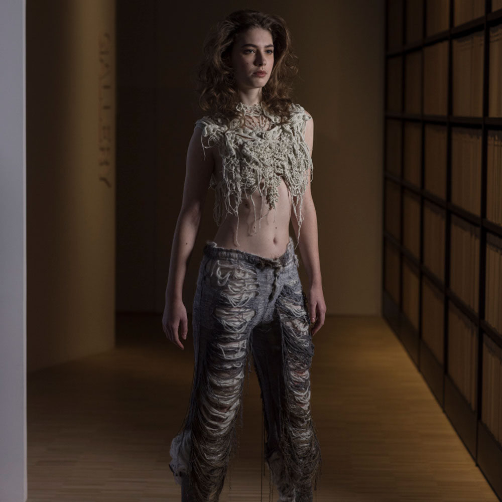 a woman standing in a dimly lit room