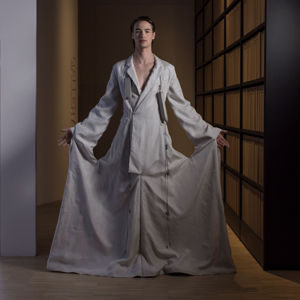 a woman standing in a room wearing a white robe