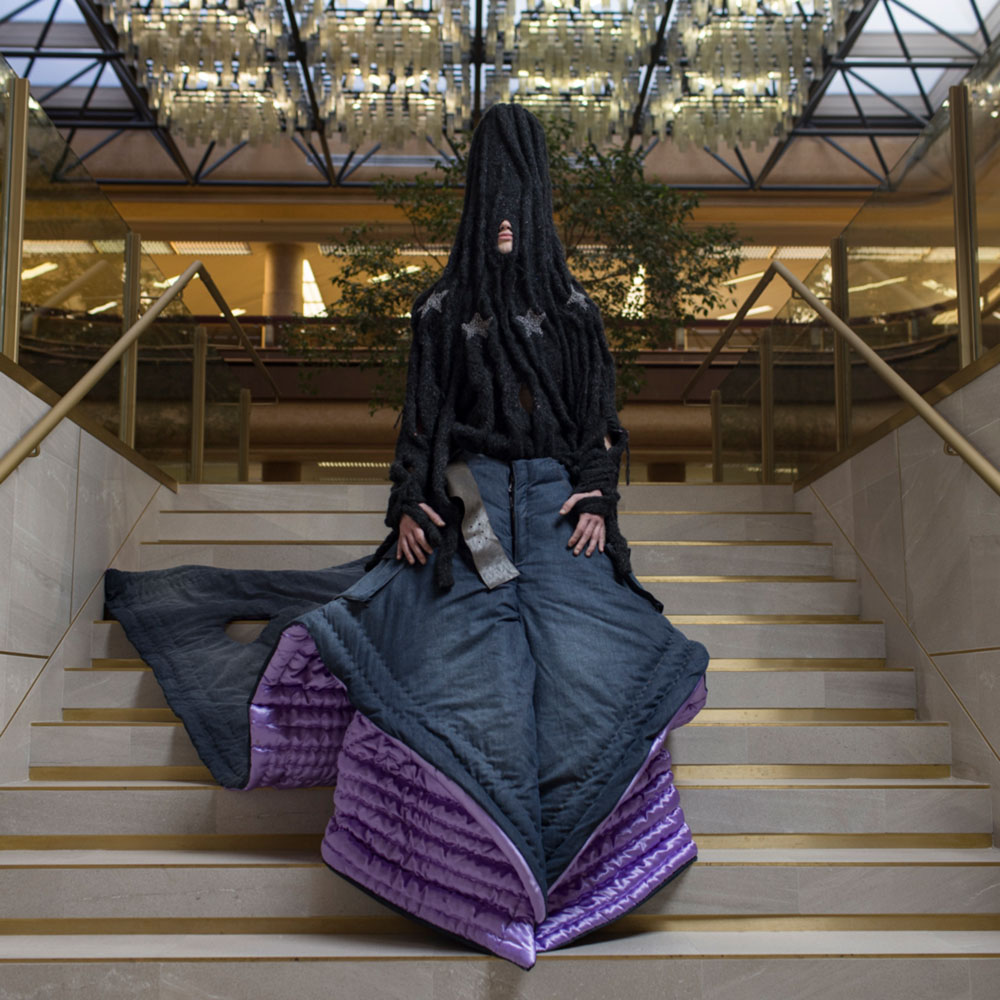 a woman is sitting on the steps of a building