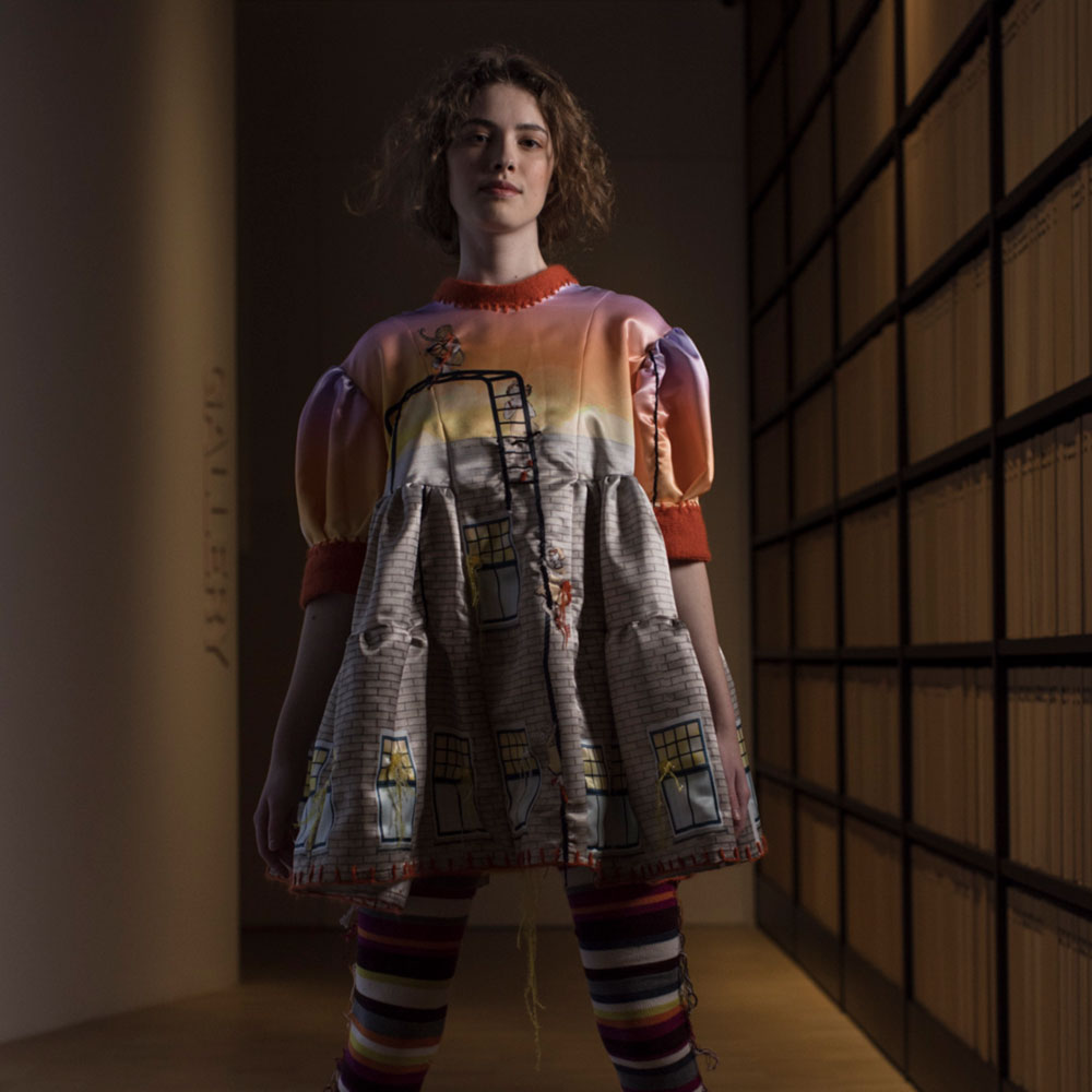 a woman is standing in a dimly lit room