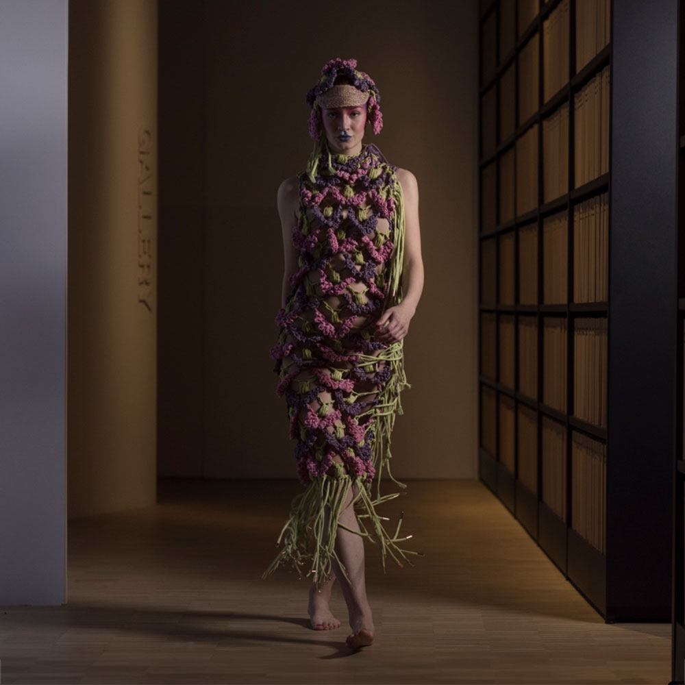 a woman in a dress made of flowers