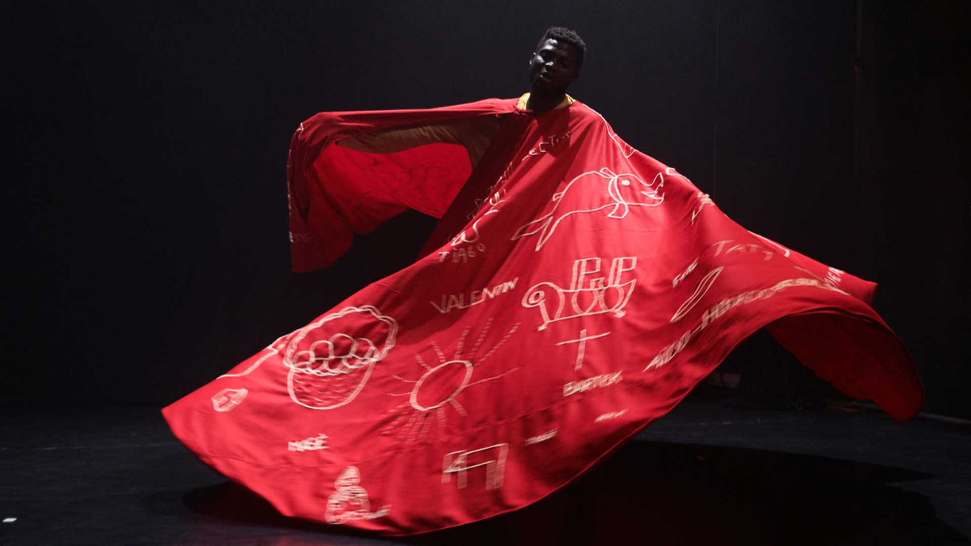 a woman in a red dress with a red cape