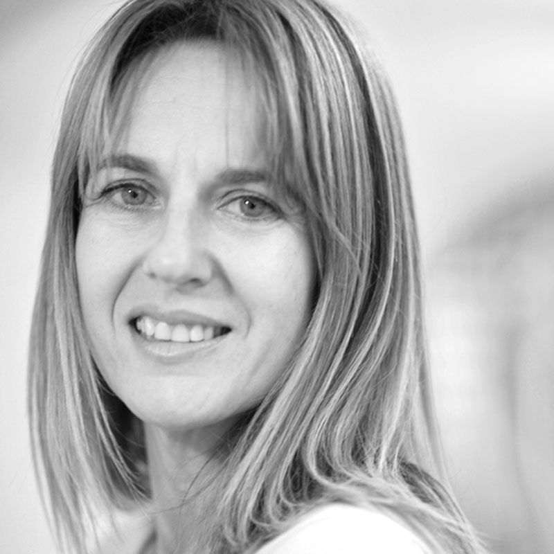 a black and white photo of a woman smiling