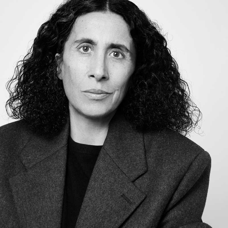 a black and white photo of a woman with curly hair
