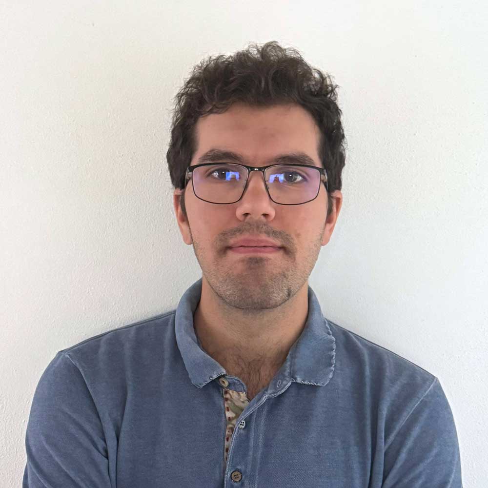 a man wearing glasses and a blue shirt