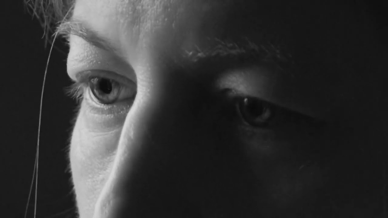 a close up of a person's face in black and white